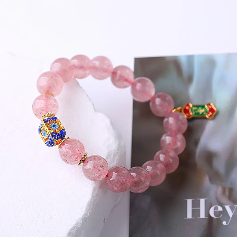Pink crystal bracelet with hand-woven design featuring Ruyi charm and text elements