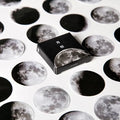 Boxed sheet of 45 black moon phase and calendar planet stickers on self-adhesive paper.