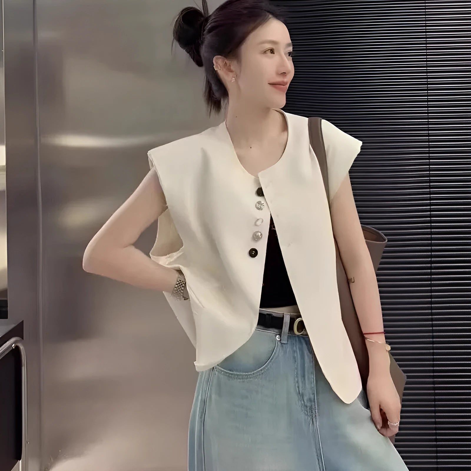 Women's loose-fit short vest in polyester, shown in milk white with side pockets.