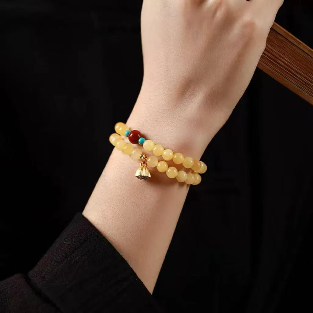 Yellow jade double ring bracelet with lotus seedpod design in hand-woven construction