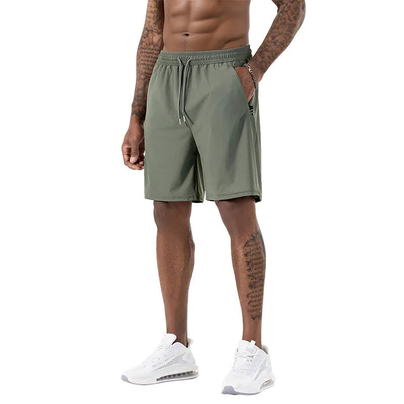 Man wearing black ice silk sport shorts with a high waist and cropped length.