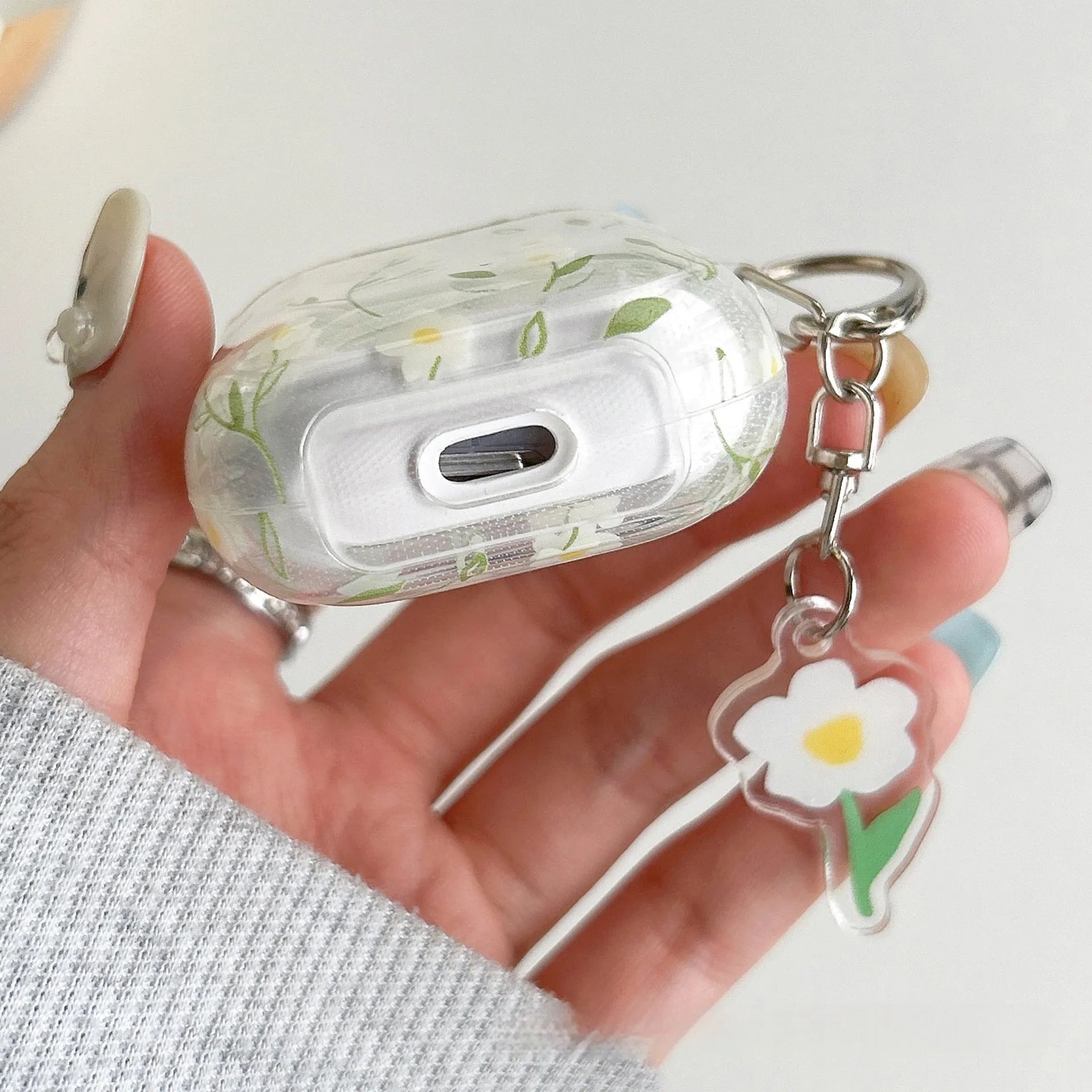 White floral high-transparency TPU protective cover for Apple AirPods showing decorative patterns