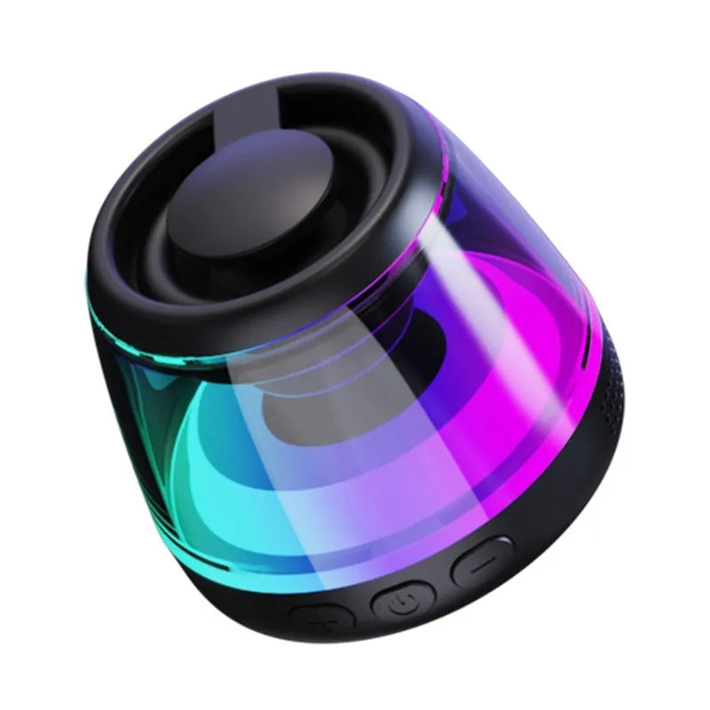 Small portable black Bluetooth speaker with coloured ambient light, shown with a magnetic base.