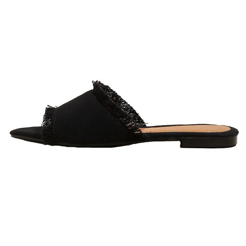 Women's denim flat slippers with tassel detail in multiple colours showing leather lining and PVC sole