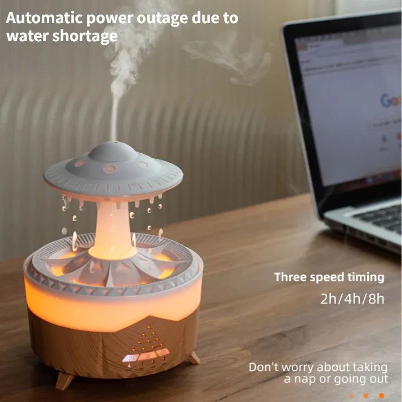 White cloud-shaped humidifier with raindrop mist and coloured night light on wooden table