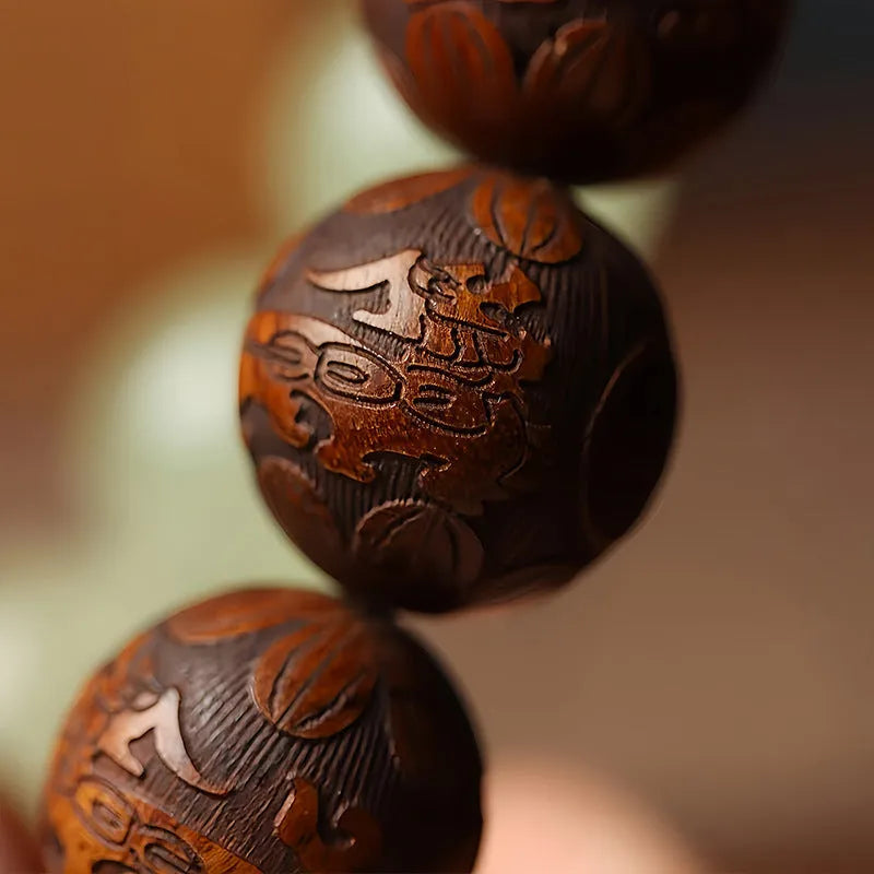 Rosewood bracelet with carved Fu character design and flexible ring construction in amass fortunes colour