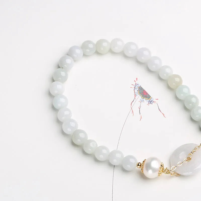 Natural emerald jade pearl bracelet with peace symbol buckle showing geometric charm arrangement