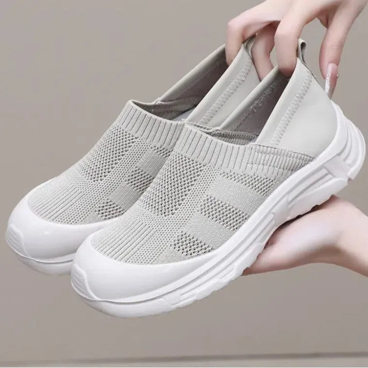 Women's beige, black and purple slip-on shoe covers with cloth upper and flat PVC sole.