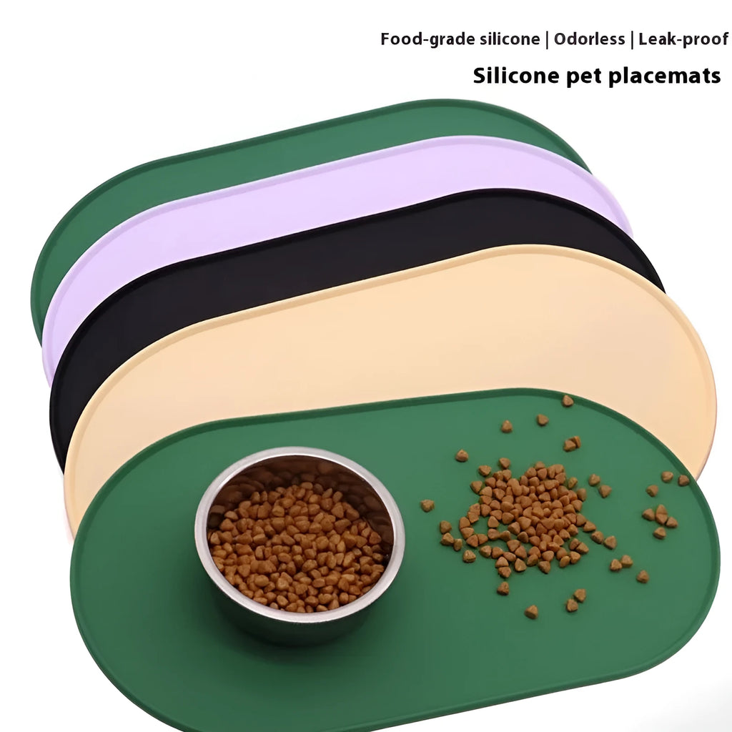 Silicone waterproof cat feeding placemat in beige colour on a floor next to a food bowl.