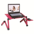 Black metal folding computer desk with cooling holes and mouse board deployed on sofa