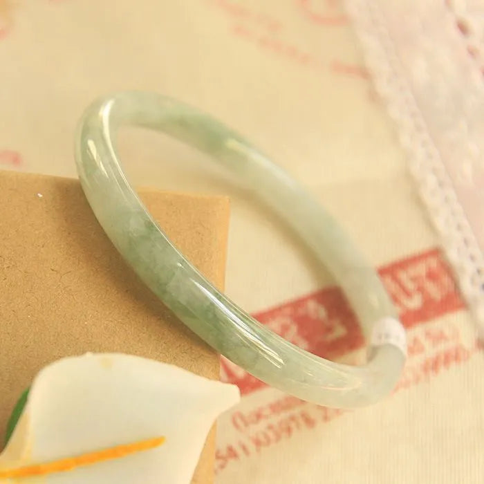 Green jade waxy finish geometric Chinese style bracelet shown on wrist, 10mm width.