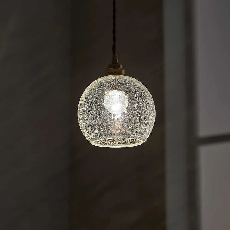 Brass and glass ball chandelier with spherical shade and metallic body