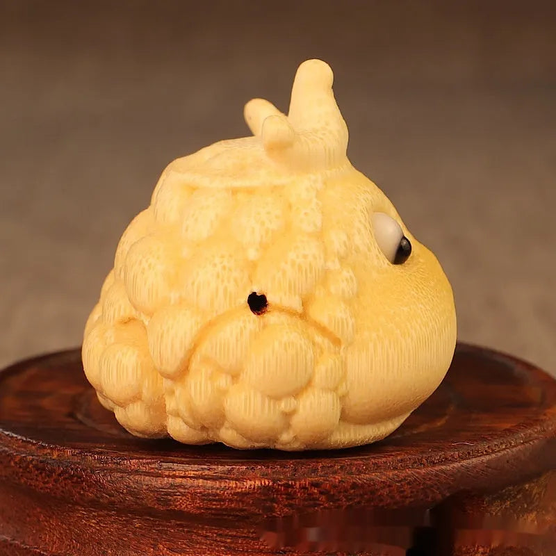 Solid bamboo carving of a Crown Princess toad ornament with live eye detail in a cute style.