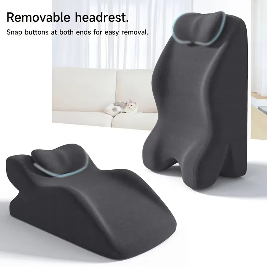 A prone position stomach sleeping pillow shown in a light grey colour, designed for use while reading in bed.