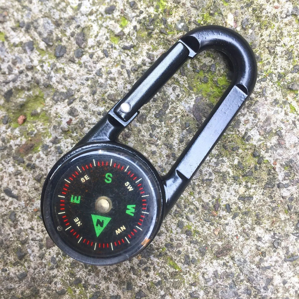 Black zinc alloy carabiner with built-in circular compass and rectangular thermometer display.