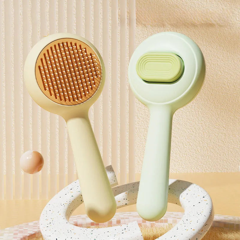 Green and yellow cat brush with stainless steel comb teeth and non-slip handle for pet grooming.