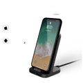 Dark grey vertical wireless charging base for Apple iPhones on desktop