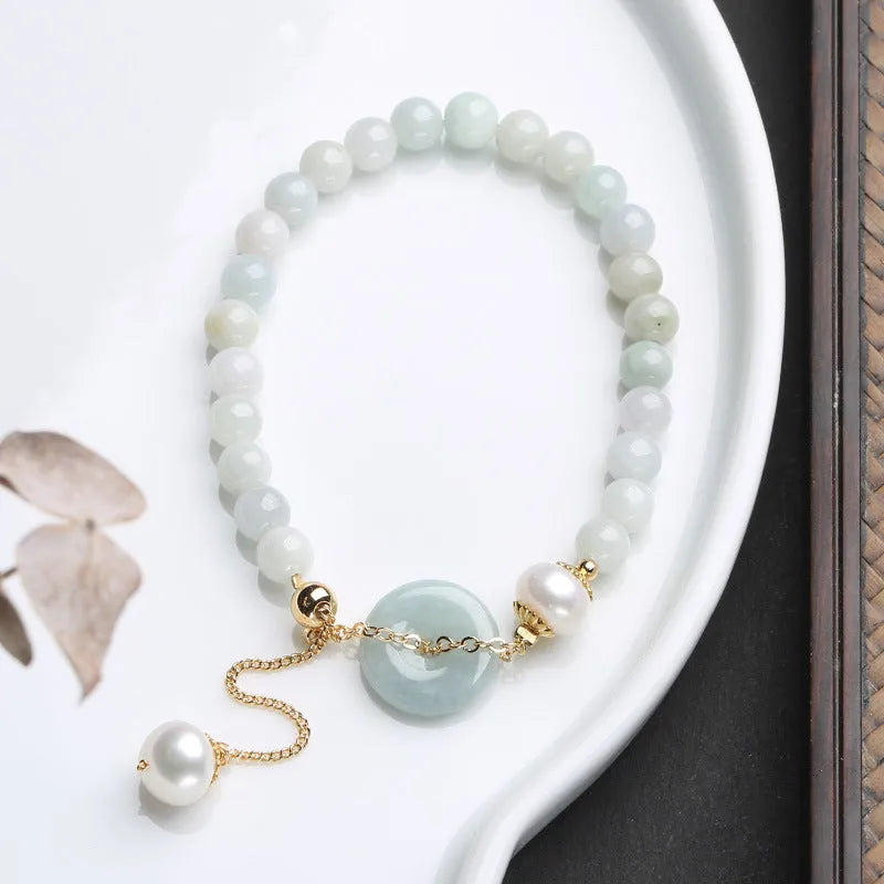 Natural emerald jade pearl bracelet with peace symbol buckle showing geometric charm arrangement