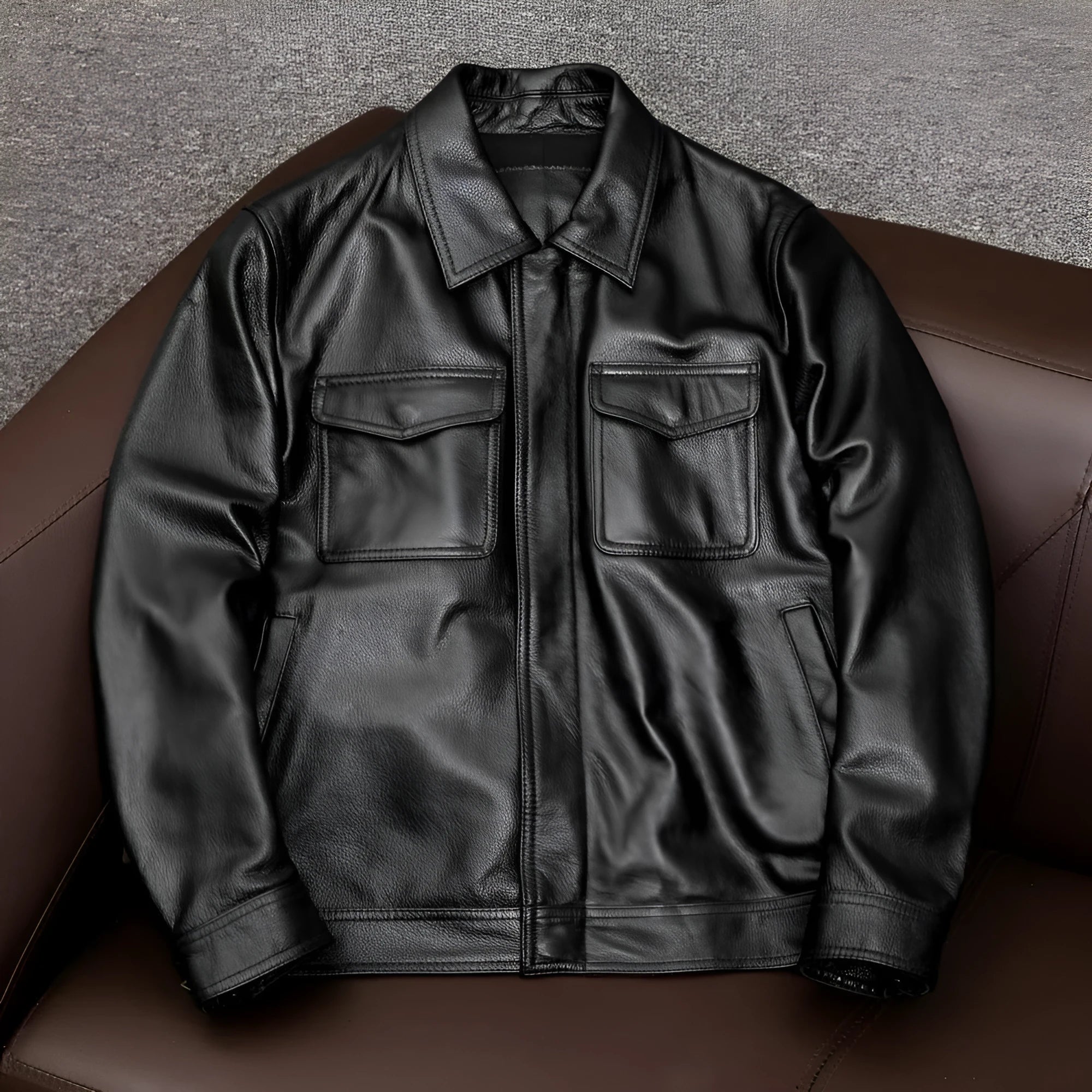 A man's black lapel short leather jacket with side pockets, shown in a loose fit.