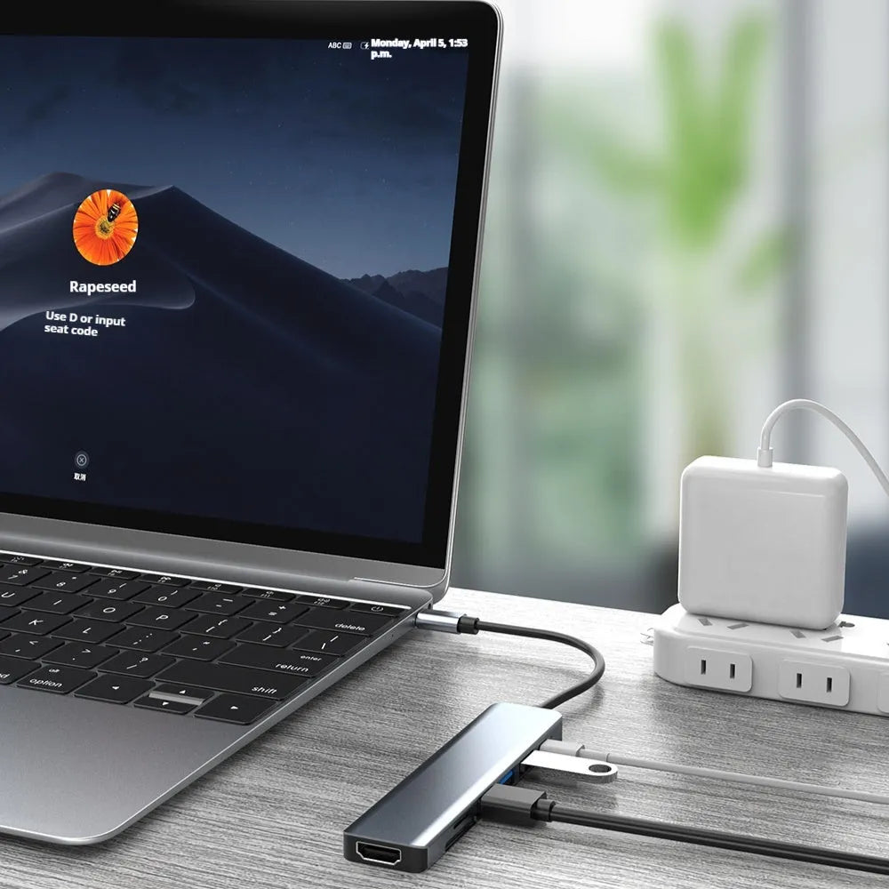 Seven-in-one USB C docking station expander hub with aluminium housing and multiple ports.