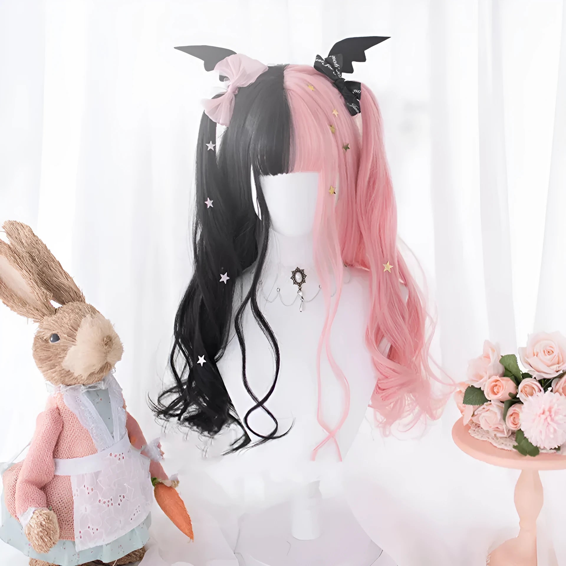 Harajuku Japanese Lolita style long curly black and pink wig with bangs on a wig stand.