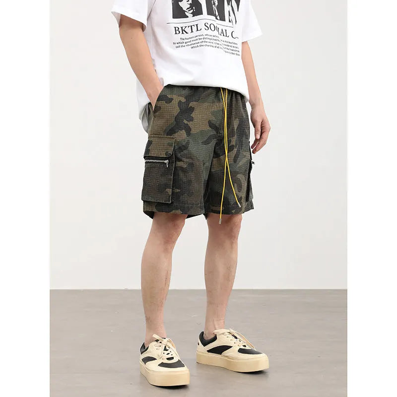 Men's camouflage cargo shorts with multiple pockets showing cropped length and mid-waist design