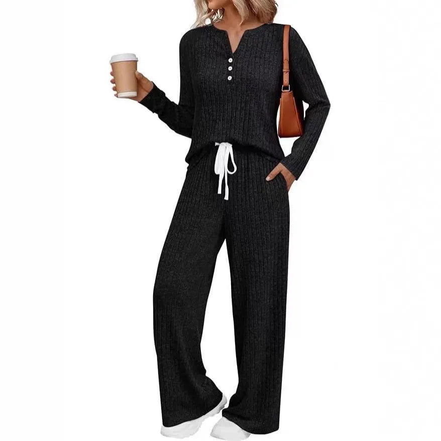 Women's light grey striped knitted long coat with v-neck, long sleeves, and lace-up detail on a mannequin.