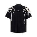 Black short-sleeved T-shirt with padded shoulders and rivet ribbon detail, loose fit with round neck