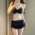 Women's solid pink and black polyester bikini swimsuit laid flat, showing top and bottom pieces.