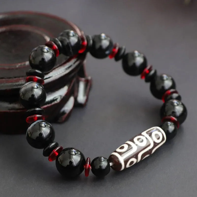 Black agate dzi bead bracelet with 11mm geometric beads in hand-woven construction