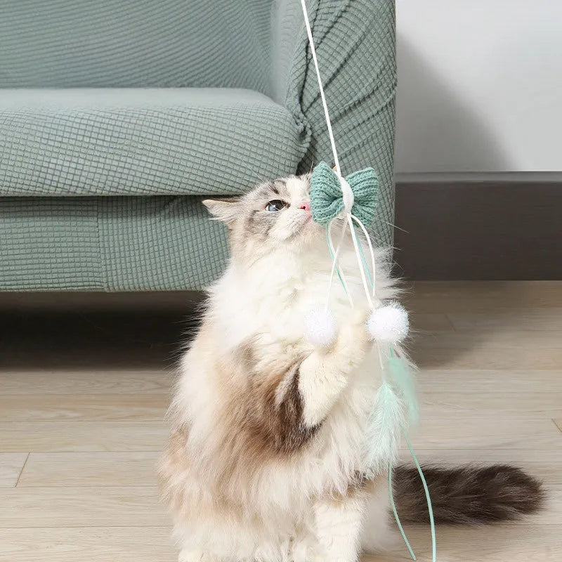 Blue rocket cat teaser toy with feathers on long pole for interactive play with kittens and cats
