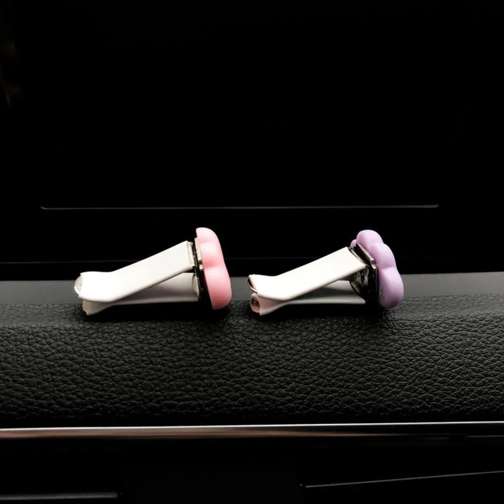 Resin Baiyun cartoon car fragrance clip in light green colour attached to a car air vent