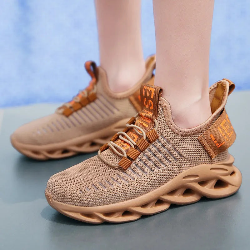 Kids' black coconut sneakers with Velcro strap, fabric upper, and chunky EVA sole.