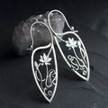 Silver lotus flower vine earrings with geometric rhinestone accents and retro styling