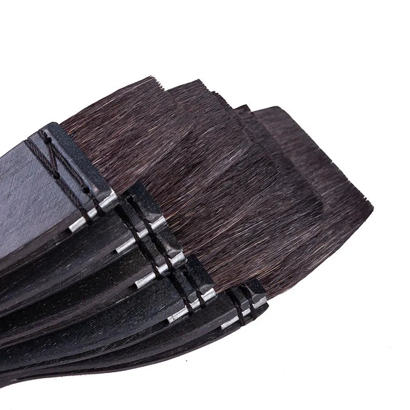Grey squirrel hair makeup brush with a light wood handle on a plain background.