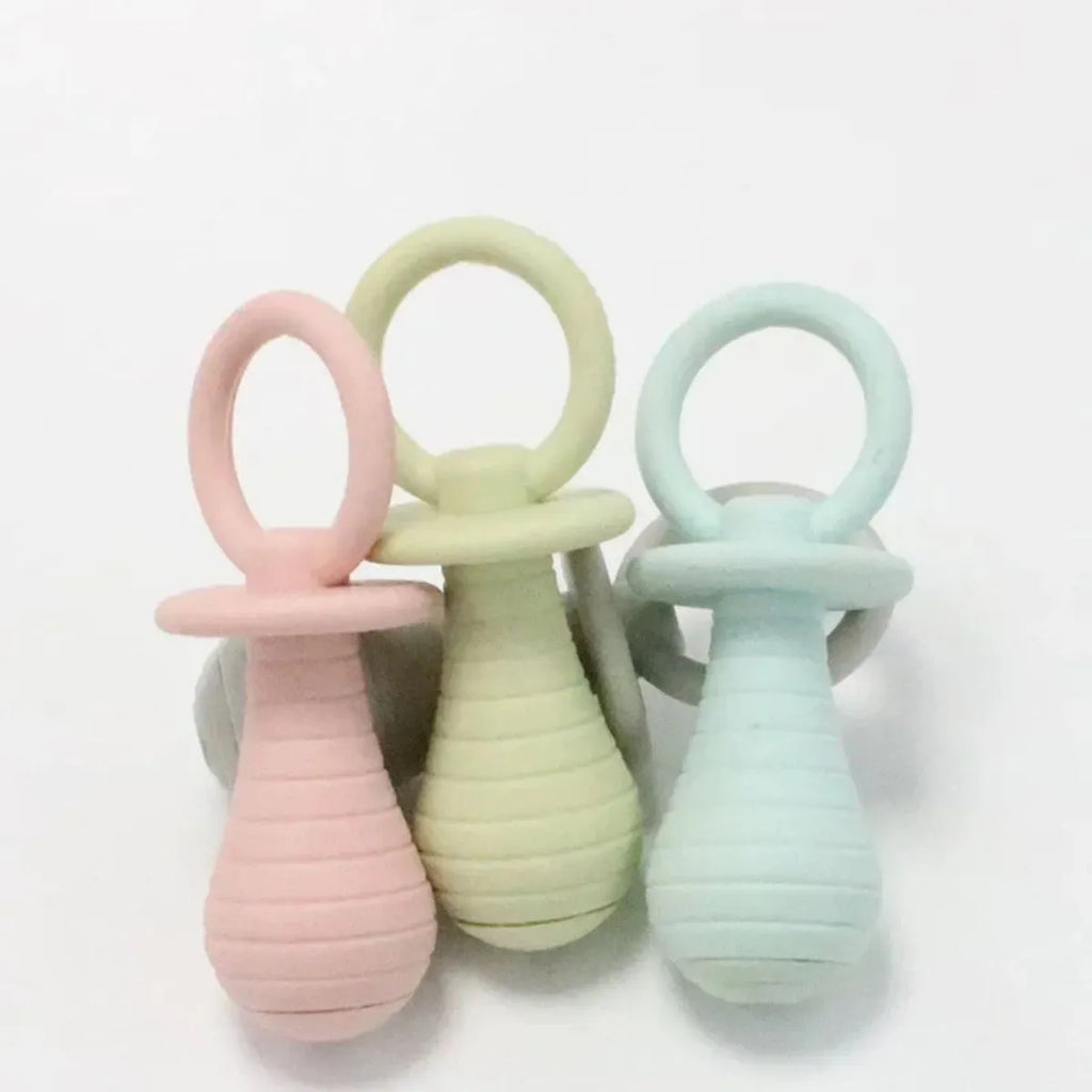 Set of four coloured TPR pet pacifier chew toys with squeakers for puppies and kittens.