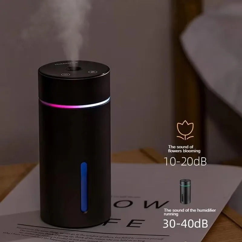 Black aluminium portable car humidifier and essential oil diffuser with night light on a desk