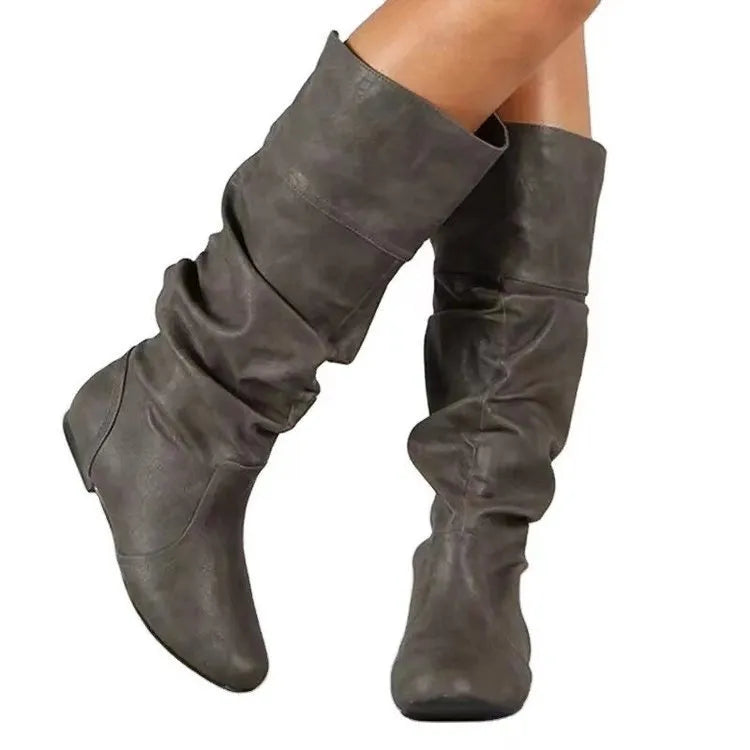 Women's black slip-on flat boots with a round toe and high cylinder shaft.