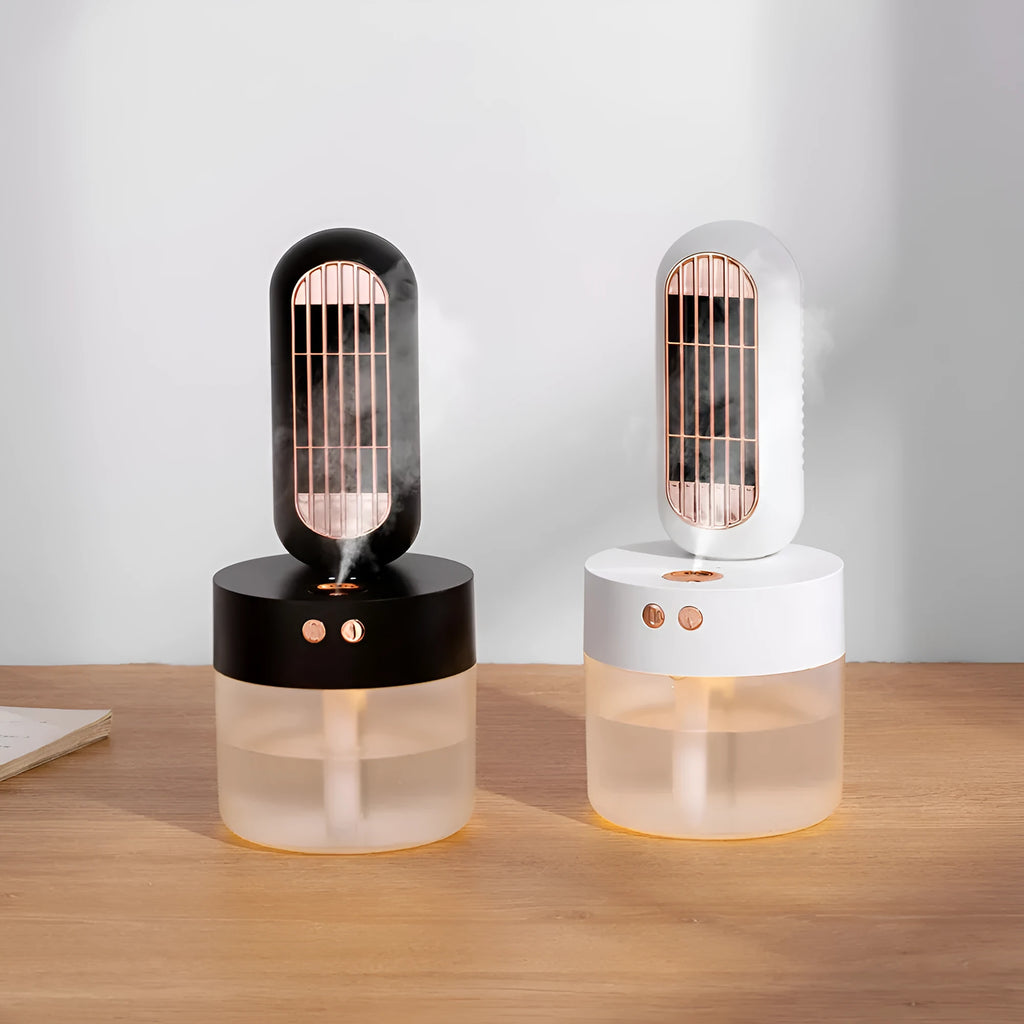 Small black and white humidifier fan with shaking head on a desktop