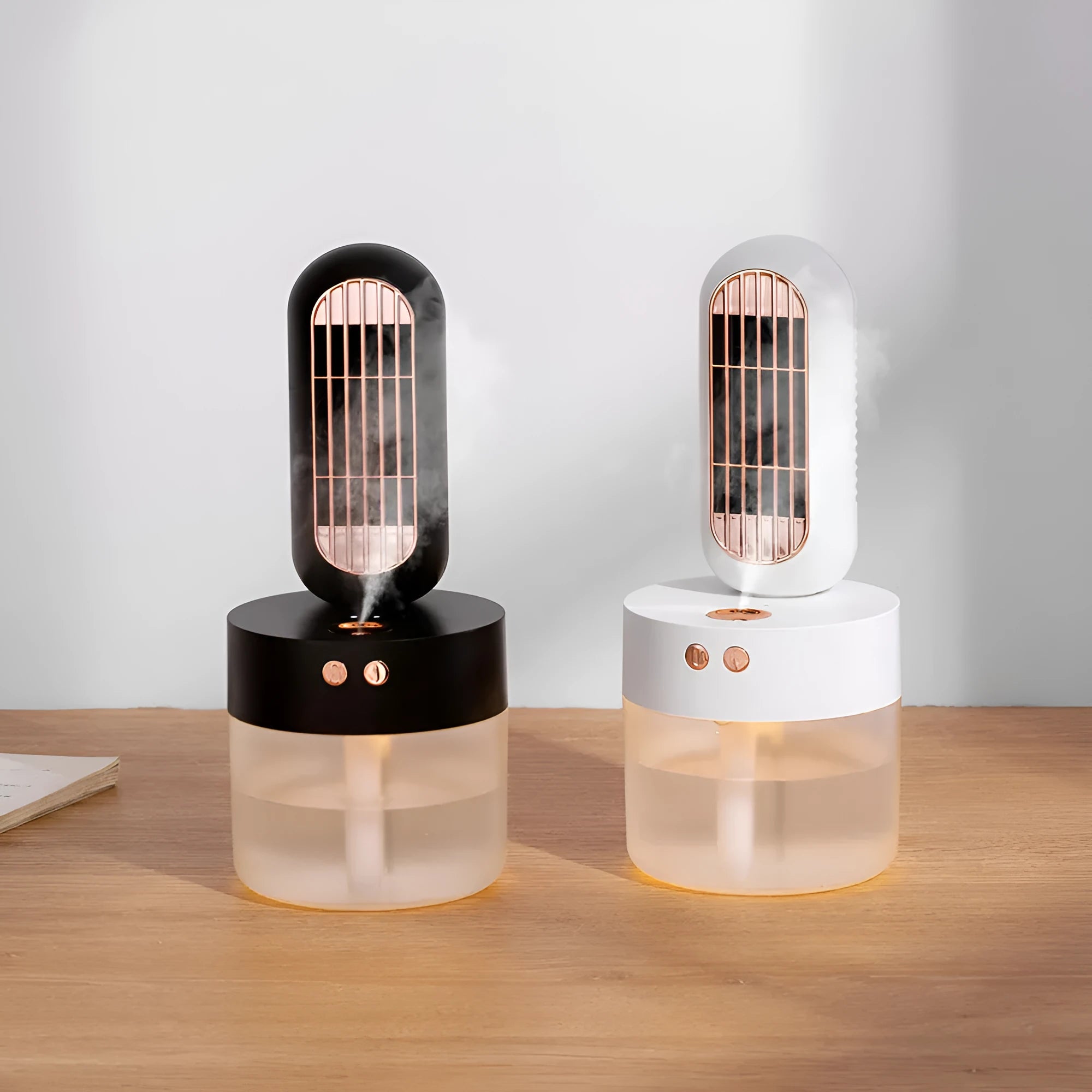 Small black and white humidifier fan with shaking head on a desktop