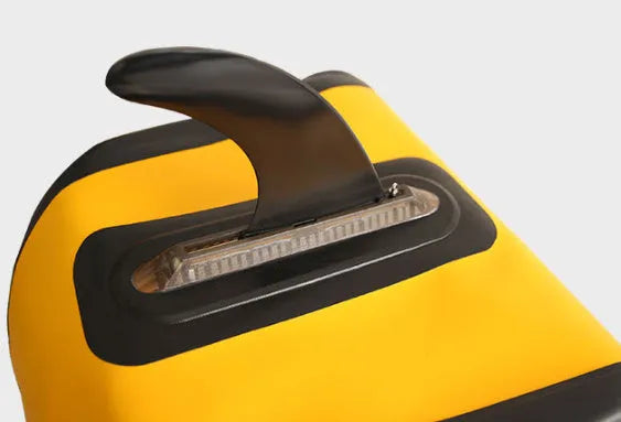 SUP paddle with removable fish fin component showing screw attachment point