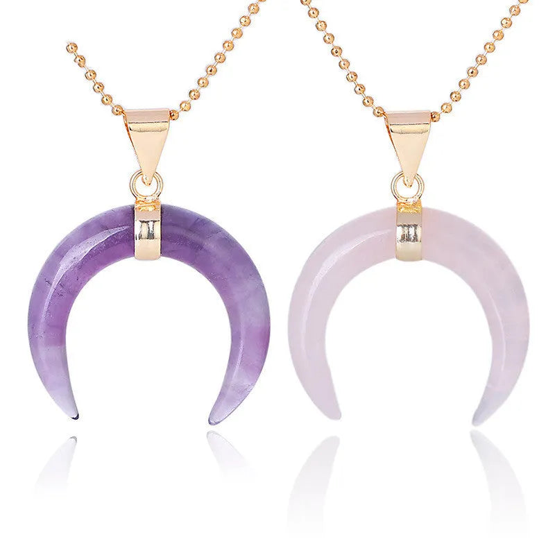 Close-up of an adjustable moon pendant necklace with a natural purple stone on a copper chain.