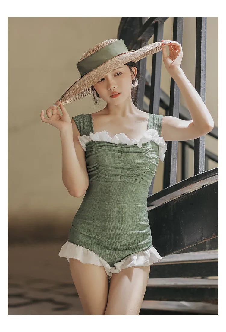 High-waist one-piece swimsuit in Korean style with slimming design available in black, pink, or green colours