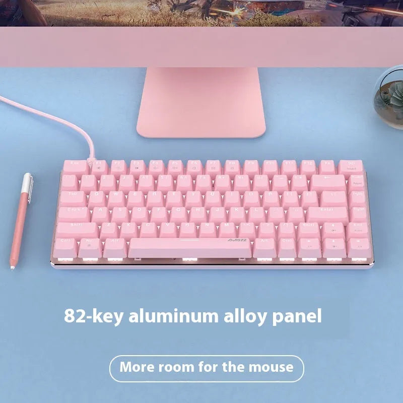 82-key mechanical keyboard with white backlight and metal housing beside laptop