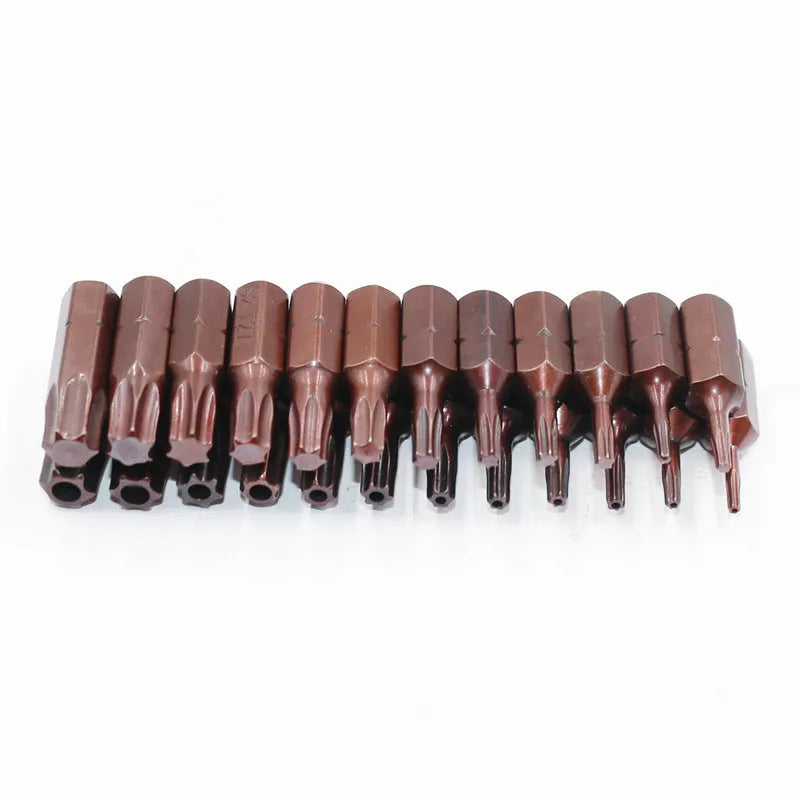 Black steel screwdriver bits T6 to T40 with hollow and solid hex heads on a magnetic strip.