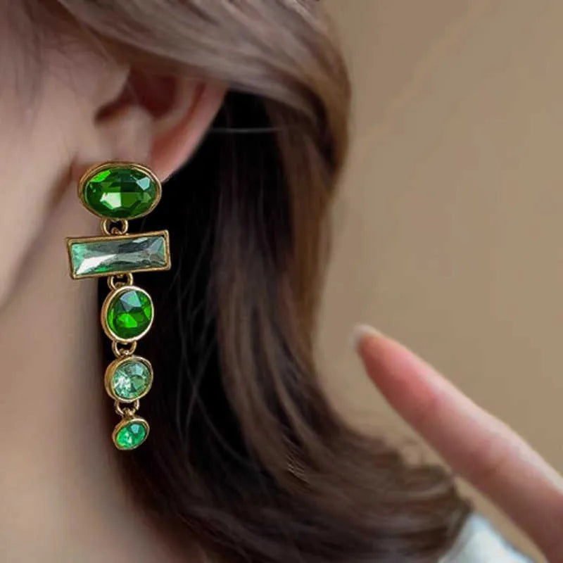 A pair of retro green gradient alloy earrings with a geometric tassel shape and inlaid zircon details.