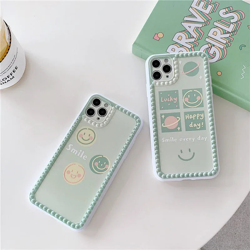 Green iPhone case with geometric smiley face and white polka dot design on a soft rubber TPU back cover.