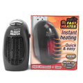 Black mini electric heater with digital display and a rotating plug on a table.