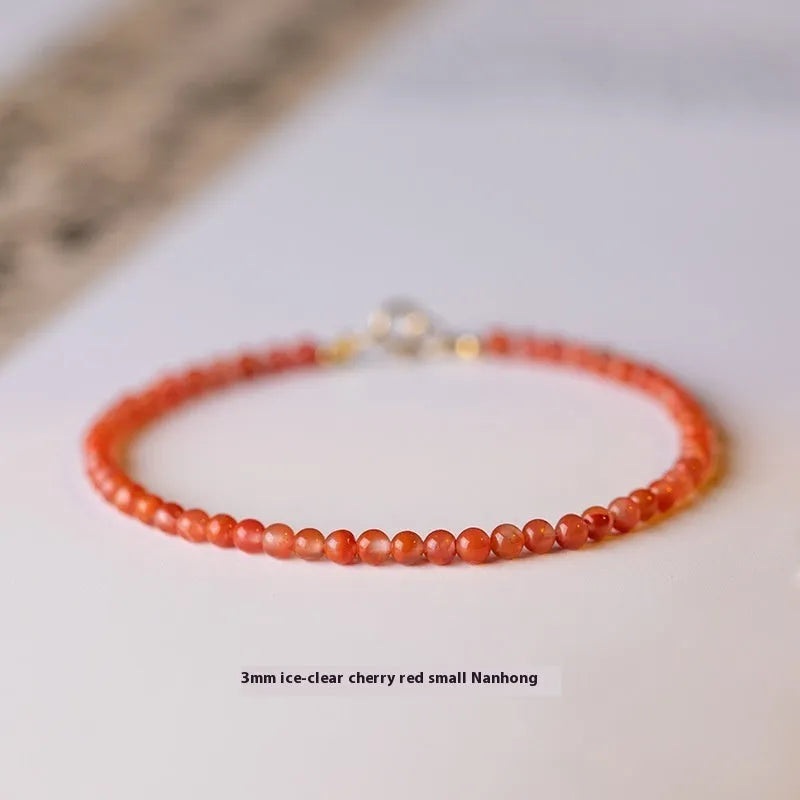 Women's Southern Red Agate bracelet in cherry red and persimmon red with 3mm cut surface, shown in retro style.