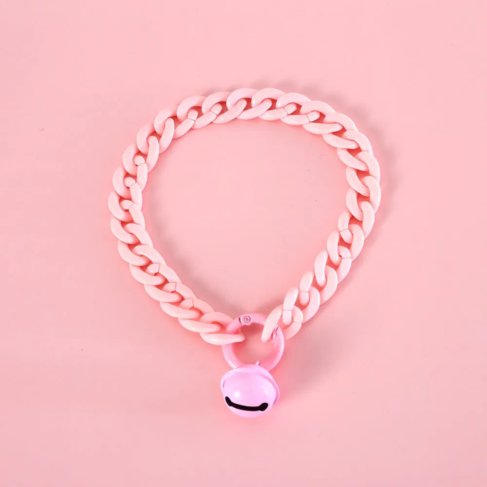 Macaron candy colour plastic collar for pet dog cat rabbit on a blue background.